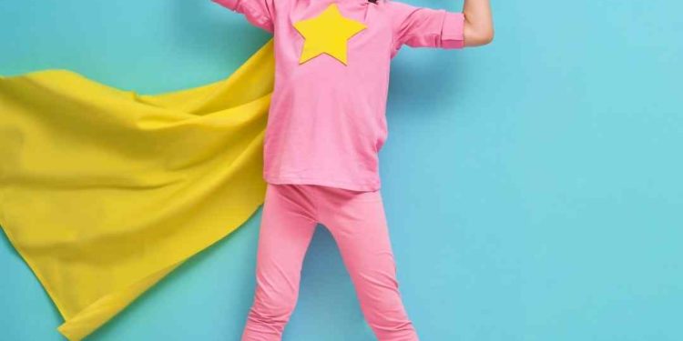 Vulnerable at work - kid dressed up in a pink and yellow superhero costume